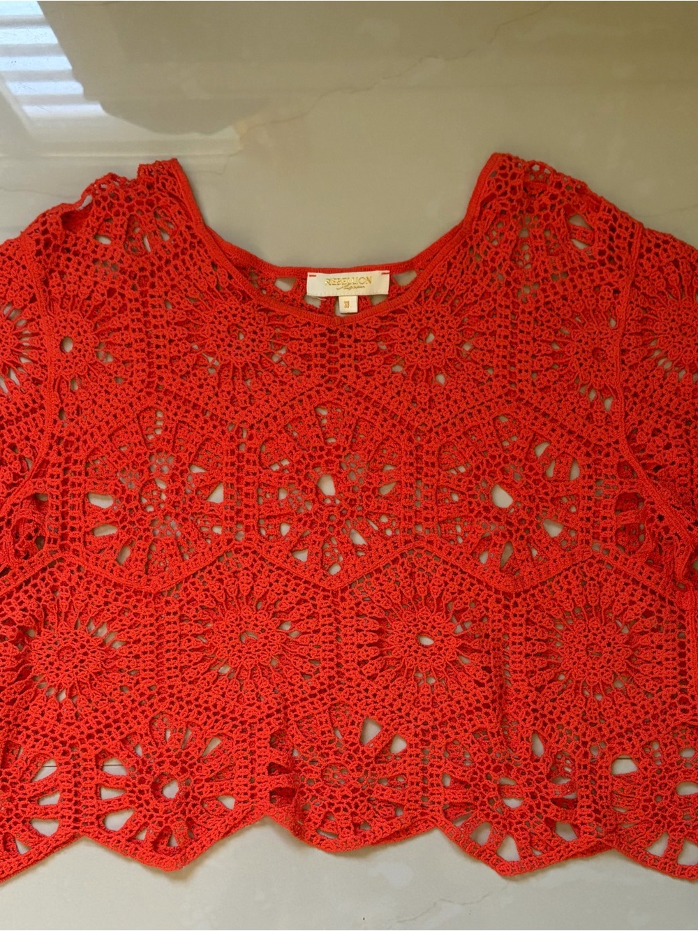 Orange crochet top.